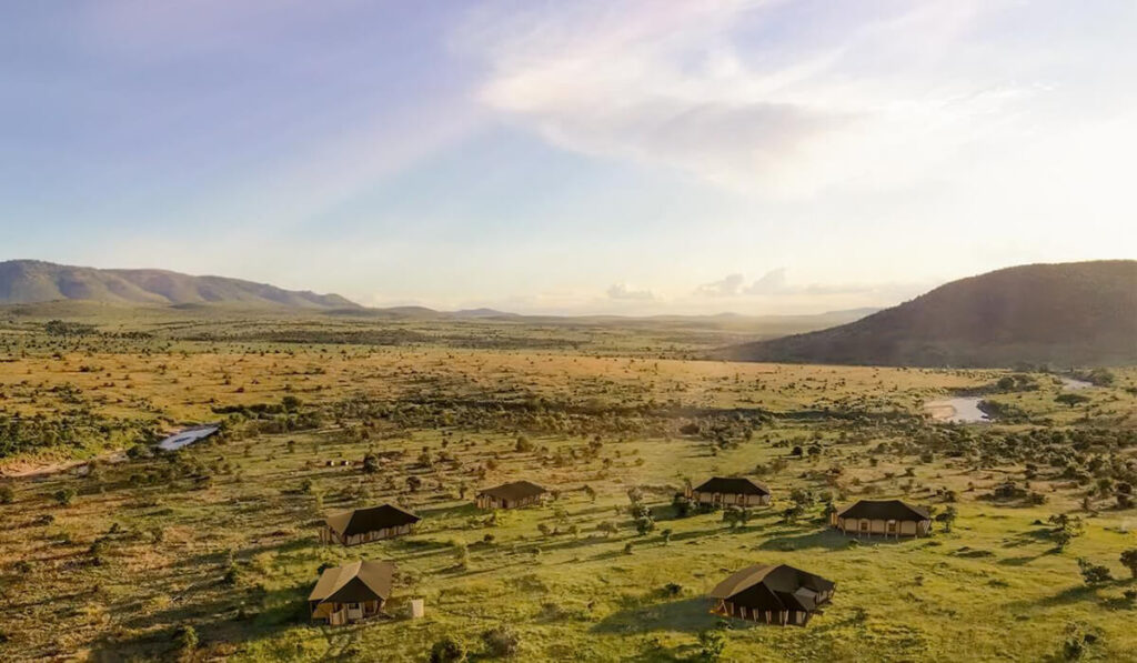 Aerial view of Little Enkewa, nestled in the heart of the Masai Mara, with luxury tents scattered across the vast savannah.
