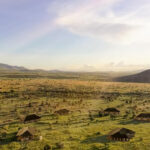 Aerial view of Little Enkewa, nestled in the heart of the Masai Mara, with luxury tents scattered across the vast savannah.