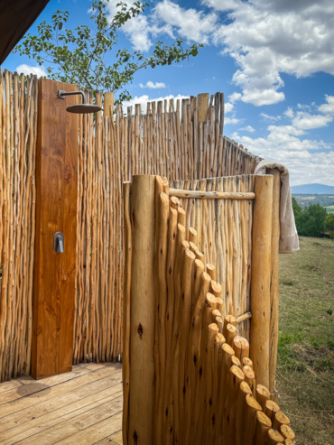 Outdoor private shower at Little Enkewa, luxury safari tent in the Masai Mara surrounded by nature