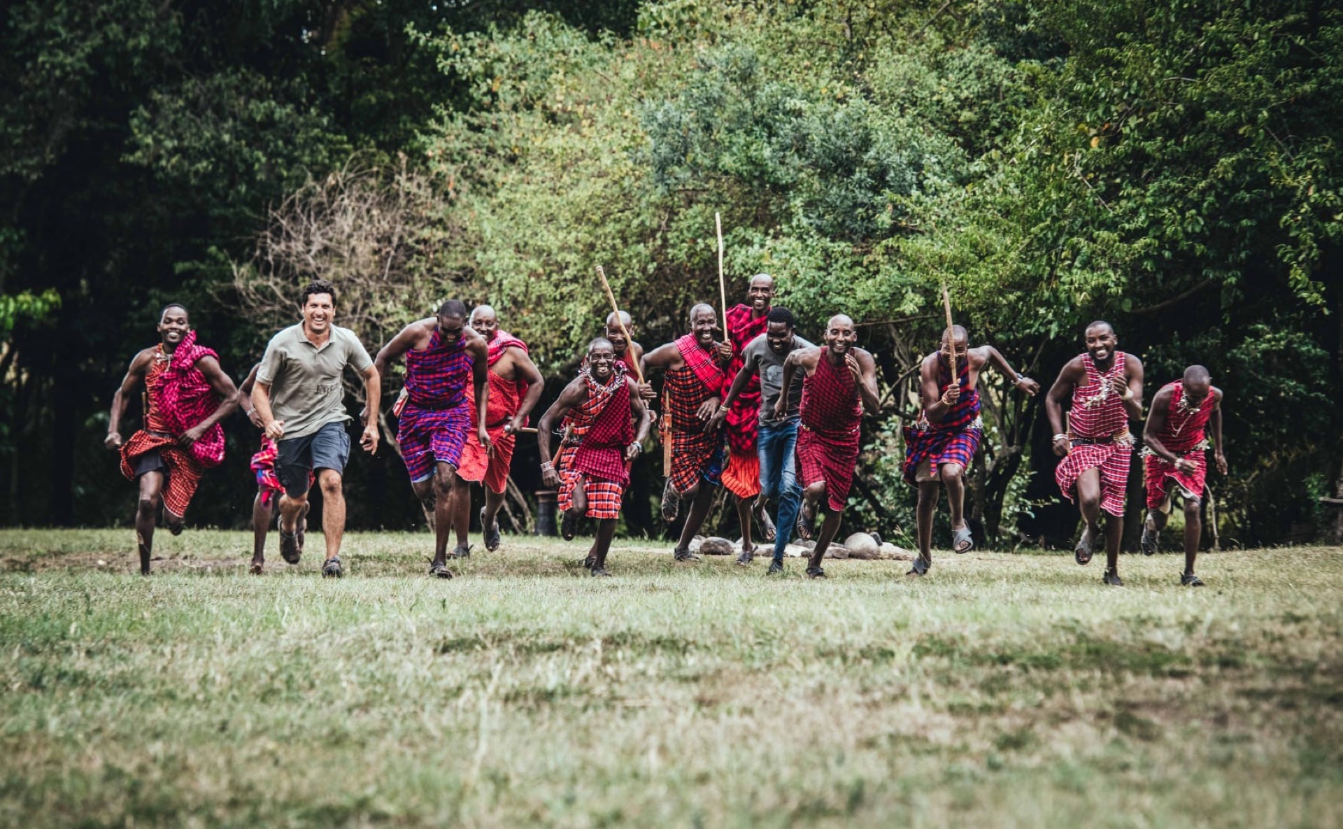 Maasai guides and spotters standing in the Masai Mara savanna
