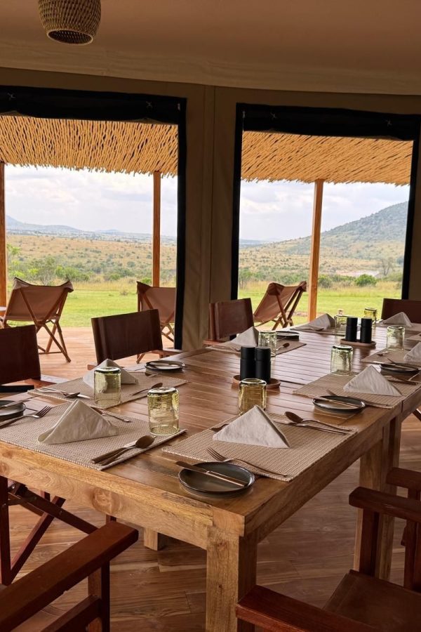 Open-sided dining area at Little Enkewa looking out over the Masai Mara savannah